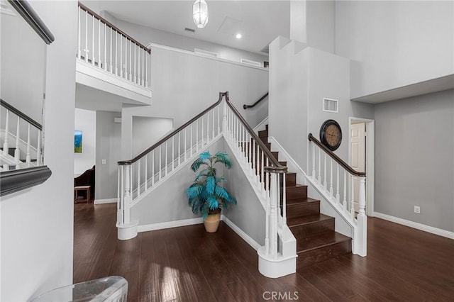 26426 Cardinal Dr, Canyon Country, CA 91387 - staircase featuring wood finished floors, baseboards, a towering ceiling, and recessed lighting