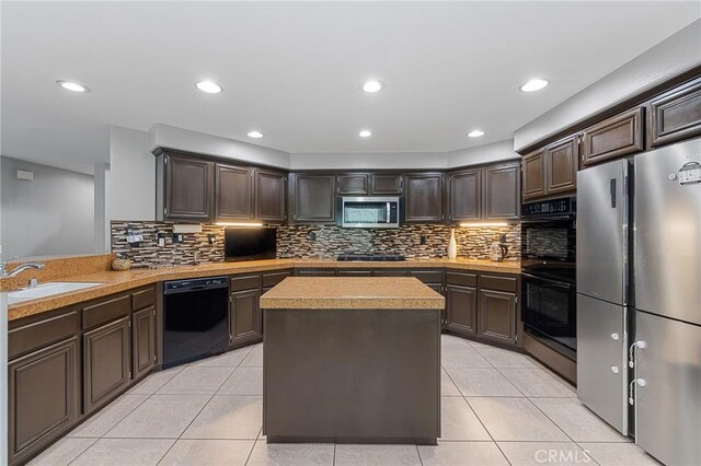 26426 Cardinal Dr, Canyon Country, CA 91387 - kitchen with black appliances, a sink, dark brown cabinets, light tile patterned floors, and recessed lighting