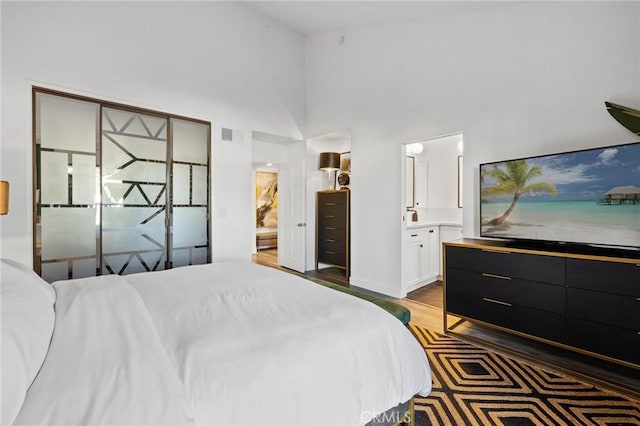 5100 Riverton Ave Unit 14, North Hollywood, CA 91601 - bedroom with ensuite bath, dark wood-type flooring, and a high ceiling