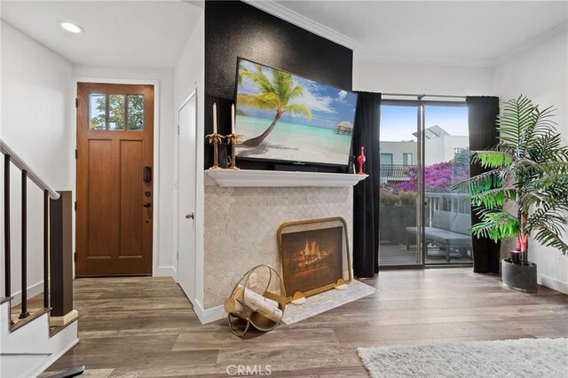 5100 Riverton Ave Unit 14, North Hollywood, CA 91601 - entryway featuring healthy amount of natural light, wood finished floors, a lit fireplace, recessed lighting, and crown molding