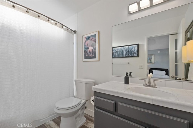 5100 Riverton Ave Unit 14, North Hollywood, CA 91601 - bathroom featuring toilet, wood finished floors, vanity, and a shower with shower curtain