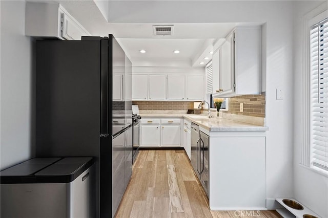 5100 Riverton Ave Unit 14, North Hollywood, CA 91601 - kitchen featuring freestanding refrigerator, light wood-style floors, white cabinets, a sink, and recessed lighting