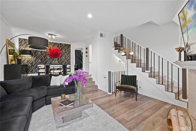 5100 Riverton Ave Unit 14, North Hollywood, CA 91601 - living room with wood finished floors, stairway, an accent wall, baseboards, and recessed lighting