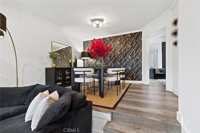 5100 Riverton Ave Unit 14, North Hollywood, CA 91601 - dining space with ornamental molding, wood finished floors, an accent wall, and baseboards