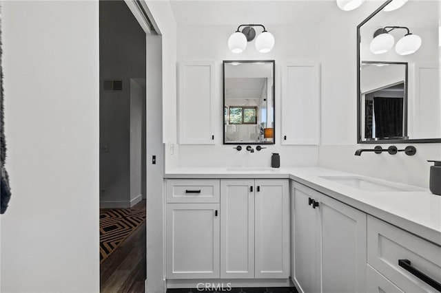 5100 Riverton Ave Unit 14, North Hollywood, CA 91601 - full bathroom featuring double vanity, wood finished floors, and baseboards