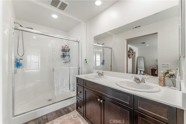 7155 Citrus Ave Unit 315, Fontana, CA 92336 - bathroom with wood finished floors, a shower stall, double vanity, and recessed lighting