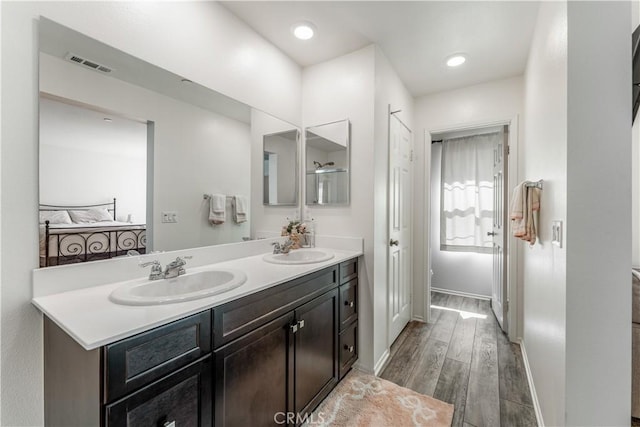 7155 Citrus Ave Unit 315, Fontana, CA 92336 - bathroom featuring wood finished floors, double vanity, and baseboards