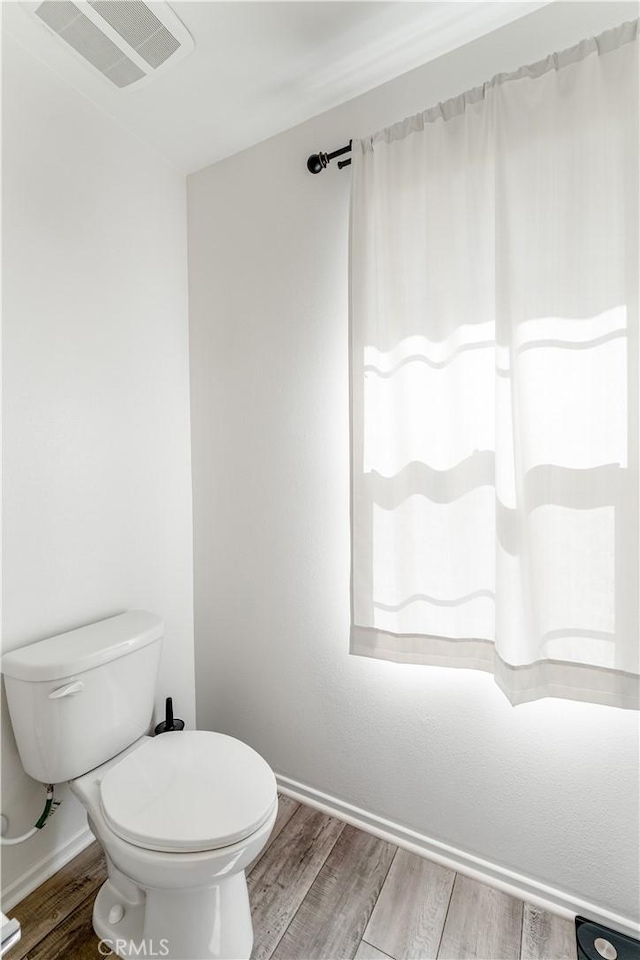 7155 Citrus Ave Unit 315, Fontana, CA 92336 - bathroom with wood finished floors, toilet, and baseboards