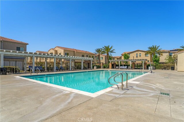 7155 Citrus Ave Unit 315, Fontana, CA 92336 - community pool featuring a pergola, a patio, fence, and a residential view