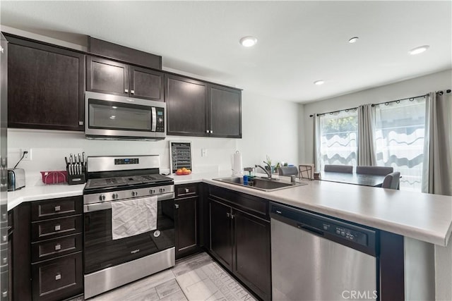 7155 Citrus Ave Unit 315, Fontana, CA 92336 - kitchen with stainless steel appliances, a peninsula, a sink, light countertops, and recessed lighting