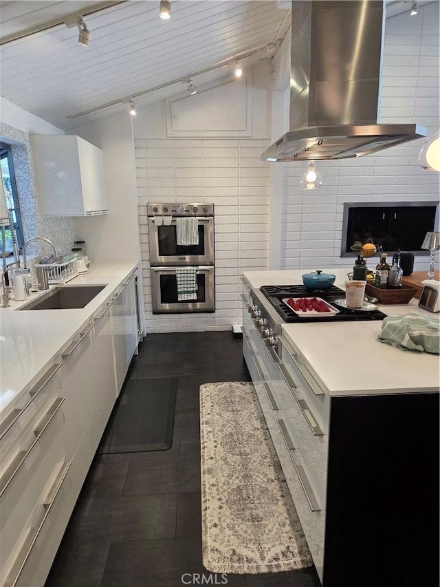 28715 Crestridge Rd, Rancho Palos Verdes, CA 90275 - kitchen featuring wall chimney exhaust hood, double oven, modern cabinets, track lighting, and vaulted ceiling