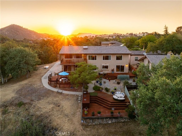 5145 Northfork Pl, Paso Robles, CA 93446 - rear view of property featuring a balcony, a patio area, a mountain view, and stucco siding