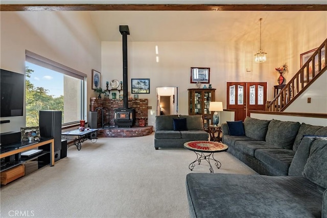 5145 Northfork Pl, Paso Robles, CA 93446 - carpeted living room with a high ceiling, a wood stove, stairs, and a chandelier