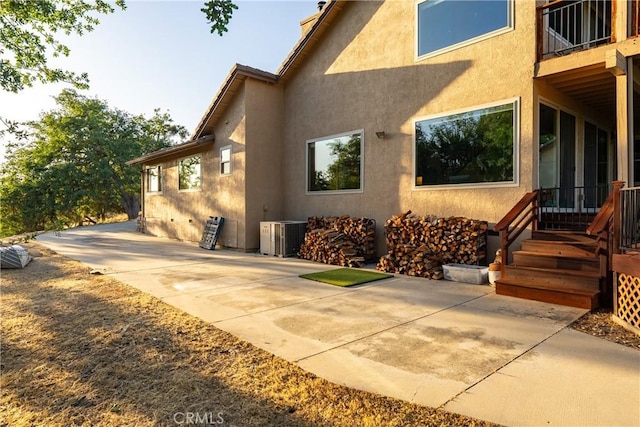 5145 Northfork Pl, Paso Robles, CA 93446 - view of side of home featuring stucco siding, central air condition unit, a patio, and a chimney