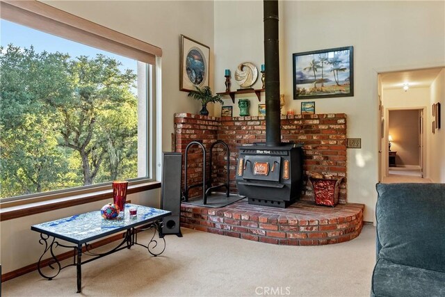 5145 Northfork Pl, Paso Robles, CA 93446 - living area featuring a wood stove, carpet floors, and healthy amount of natural light