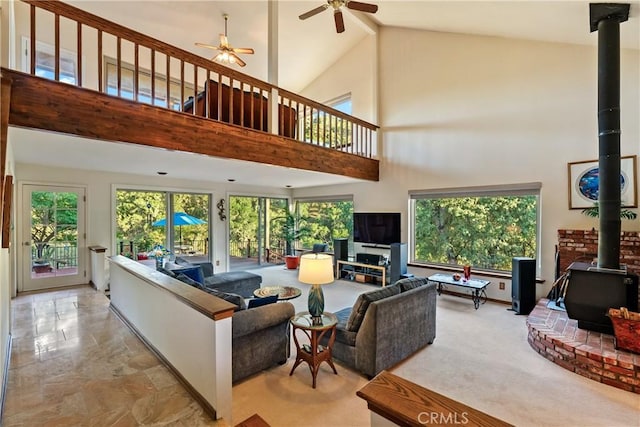 5145 Northfork Pl, Paso Robles, CA 93446 - living area with a wood stove, a ceiling fan, plenty of natural light, and a high ceiling