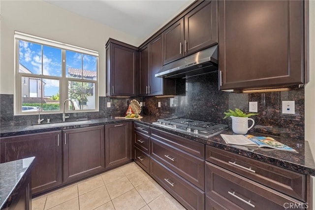 124 Trumpet Flower, Irvine, CA 92618 - kitchen featuring under cabinet range hood, a sink, stainless steel gas cooktop, light tile patterned floors, and dark stone counters