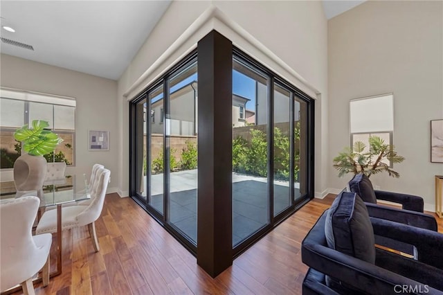 124 Trumpet Flower, Irvine, CA 92618 - doorway to outside featuring wood finished floors, vaulted ceiling, and baseboards