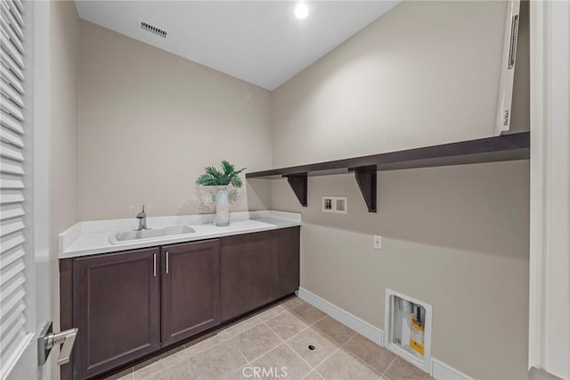 124 Trumpet Flower, Irvine, CA 92618 - clothes washing area with washer hookup, cabinet space, electric dryer hookup, baseboards, and light tile patterned flooring