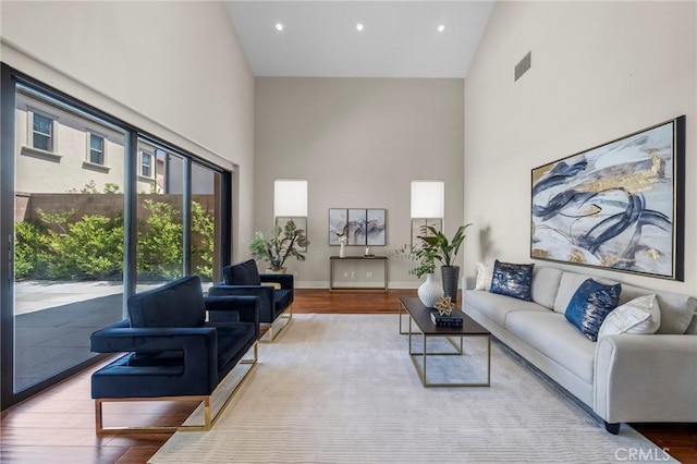 124 Trumpet Flower, Irvine, CA 92618 - living area featuring high vaulted ceiling, wood finished floors, baseboards, and recessed lighting