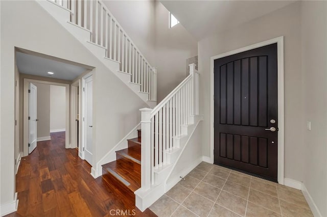 124 Trumpet Flower, Irvine, CA 92618 - entrance foyer with stairs, baseboards, a high ceiling, and wood finished floors