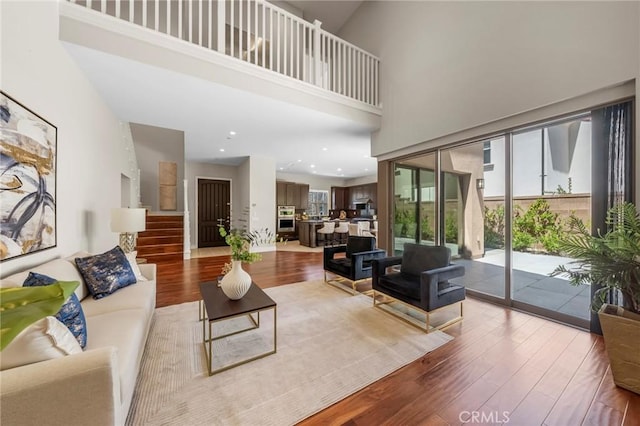 124 Trumpet Flower, Irvine, CA 92618 - living room with wood finished floors, a towering ceiling, and recessed lighting