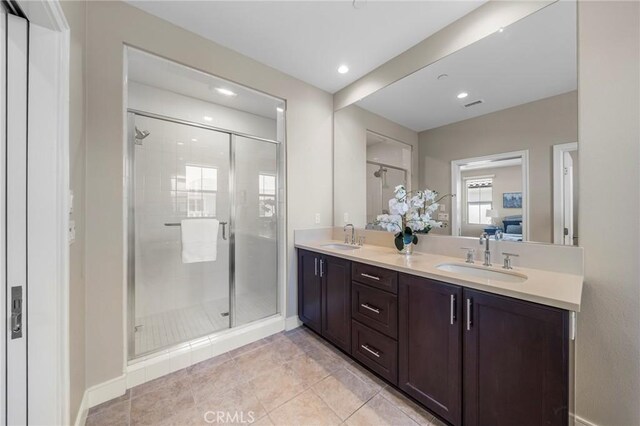 124 Trumpet Flower, Irvine, CA 92618 - ensuite bathroom featuring a shower stall, double vanity, recessed lighting, tile patterned floors, and baseboards
