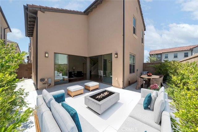 124 Trumpet Flower, Irvine, CA 92618 - back of property featuring an outdoor living space with a fire pit, a patio, stucco siding, and fence