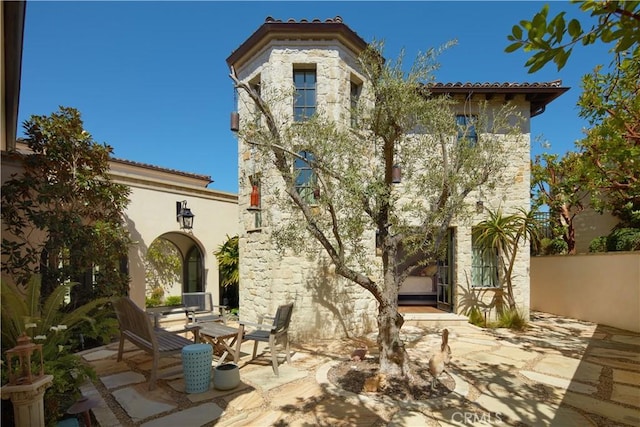 17 Pacific Ridge Pl, Dana Point, CA 92629 - rear view of property with a patio area, stone siding, and a tiled roof