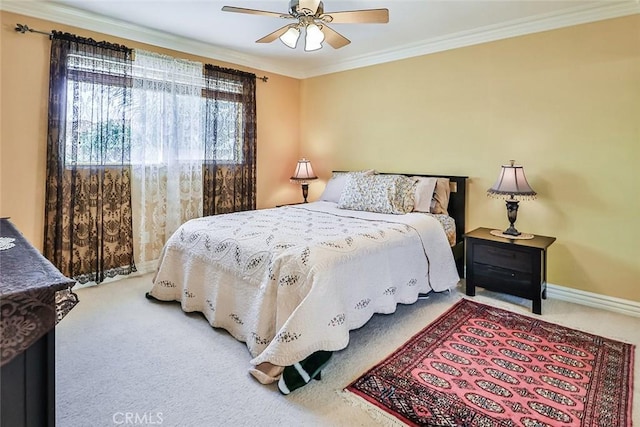 carpeted bedroom with ornamental molding, baseboards, and a ceiling fan