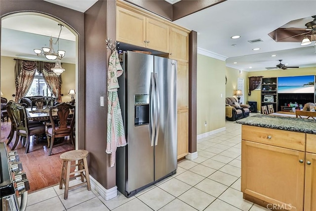 kitchen featuring stainless steel refrigerator with ice dispenser, light tile patterned floors, crown molding, open floor plan, and ceiling fan