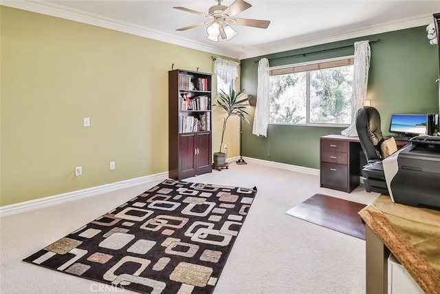 carpeted office space with baseboards, ornamental molding, and a ceiling fan