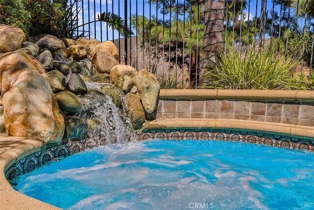 view of pool featuring a hot tub
