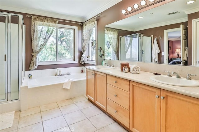 bathroom featuring a shower stall, ensuite bath, a garden tub, double vanity, and tile patterned floors