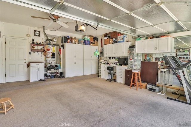 garage featuring a garage door opener, an office area, and ceiling fan