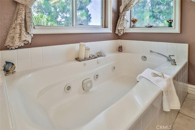 full bathroom featuring plenty of natural light, a whirlpool tub, and tile patterned flooring