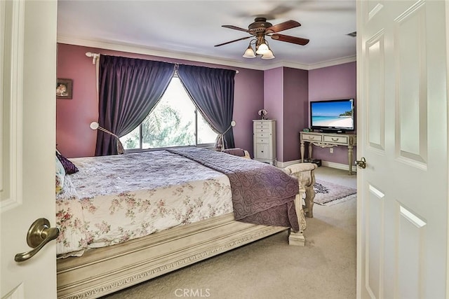 bedroom with carpet flooring, crown molding, and a ceiling fan