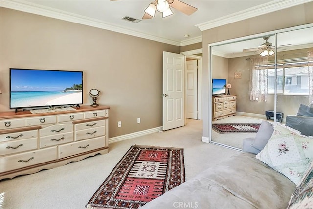 bedroom featuring light carpet, crown molding, baseboards, and a closet