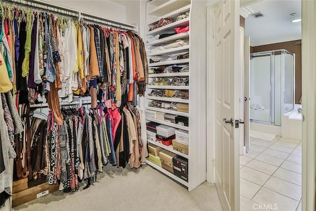 walk in closet with tile patterned flooring