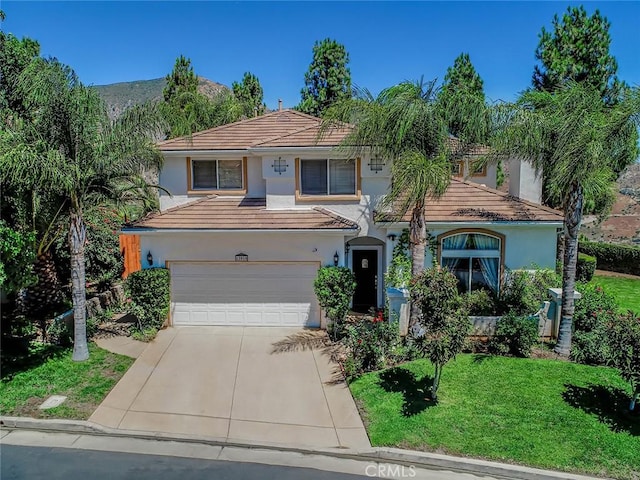traditional-style house featuring stucco siding, an attached garage, driveway, a front yard, and a tile roof