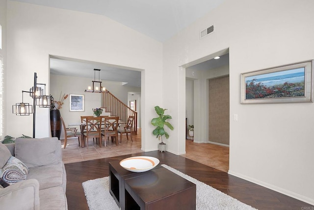 2217 Corte, San Simeon, Chula Vista, CA 91914 - living room with wood finished floors, stairway, high vaulted ceiling, a chandelier, and baseboards