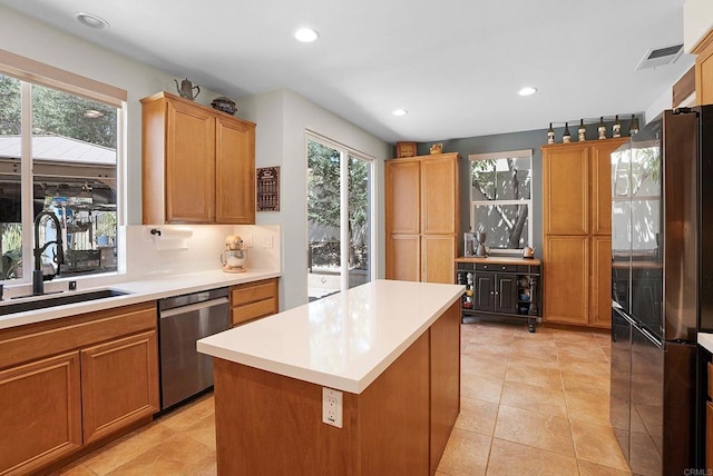2217 Corte, San Simeon, Chula Vista, CA 91914 - kitchen with stainless steel dishwasher, a sink, light countertops, recessed lighting, and freestanding refrigerator