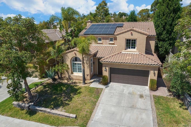 2217 Corte, San Simeon, Chula Vista, CA 91914 - mediterranean / spanish-style home featuring a tiled roof, stucco siding, concrete driveway, roof mounted solar panels, and a front yard