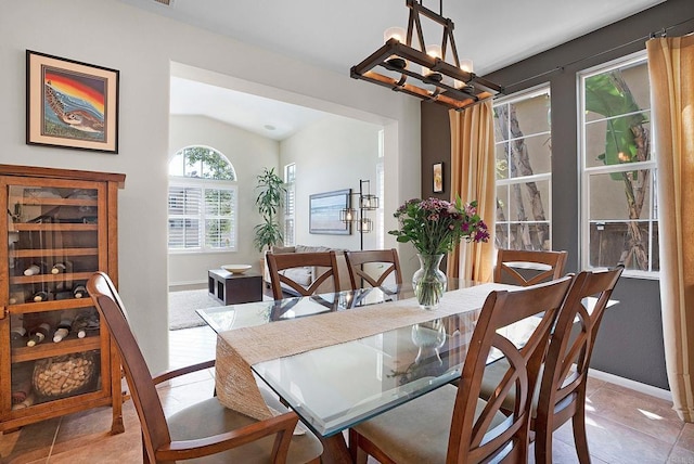 2217 Corte, San Simeon, Chula Vista, CA 91914 - dining room featuring a chandelier, vaulted ceiling, baseboards, and light tile patterned floors