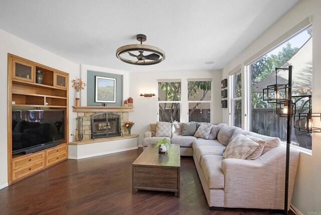 2217 Corte, San Simeon, Chula Vista, CA 91914 - living room with hardwood / wood-style floors, a fireplace with raised hearth, and baseboards