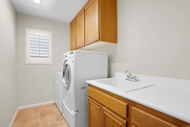 2217 Corte, San Simeon, Chula Vista, CA 91914 - washroom with independent washer and dryer, cabinet space, baseboards, and light tile patterned floors