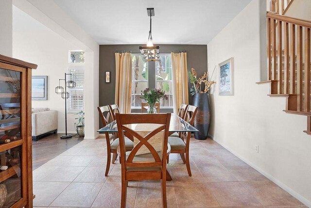 2217 Corte, San Simeon, Chula Vista, CA 91914 - dining area with a chandelier, stairway, baseboards, and light tile patterned floors