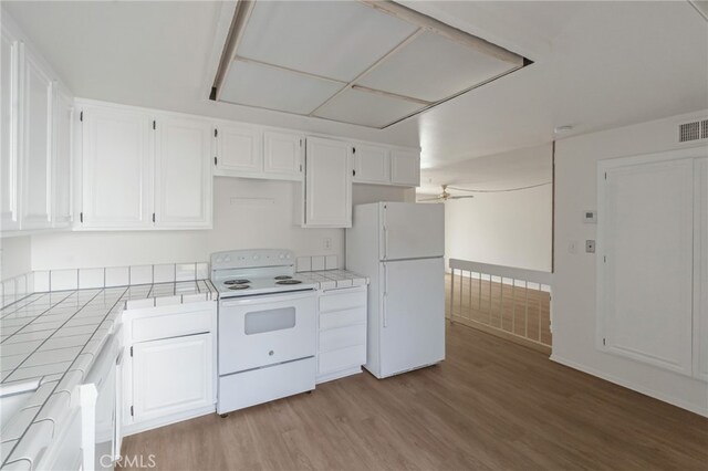 kitchen featuring white appliances, tile countertops, light wood-type flooring, white cabinets, and a ceiling fan