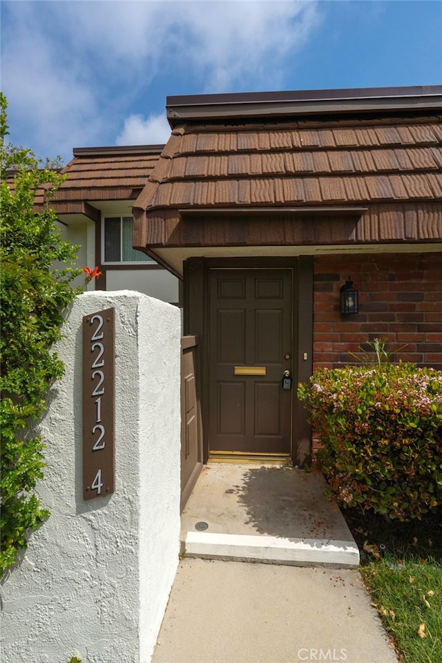 doorway to property with stucco siding