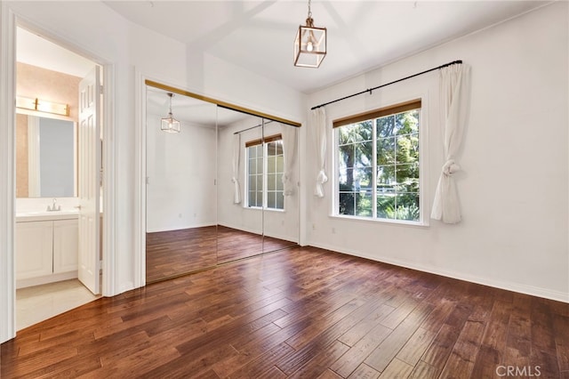 2117 Brittany Park Rd, Camarillo, CA 93012 - empty room featuring hardwood / wood-style flooring, a sink, baseboards, and a chandelier
